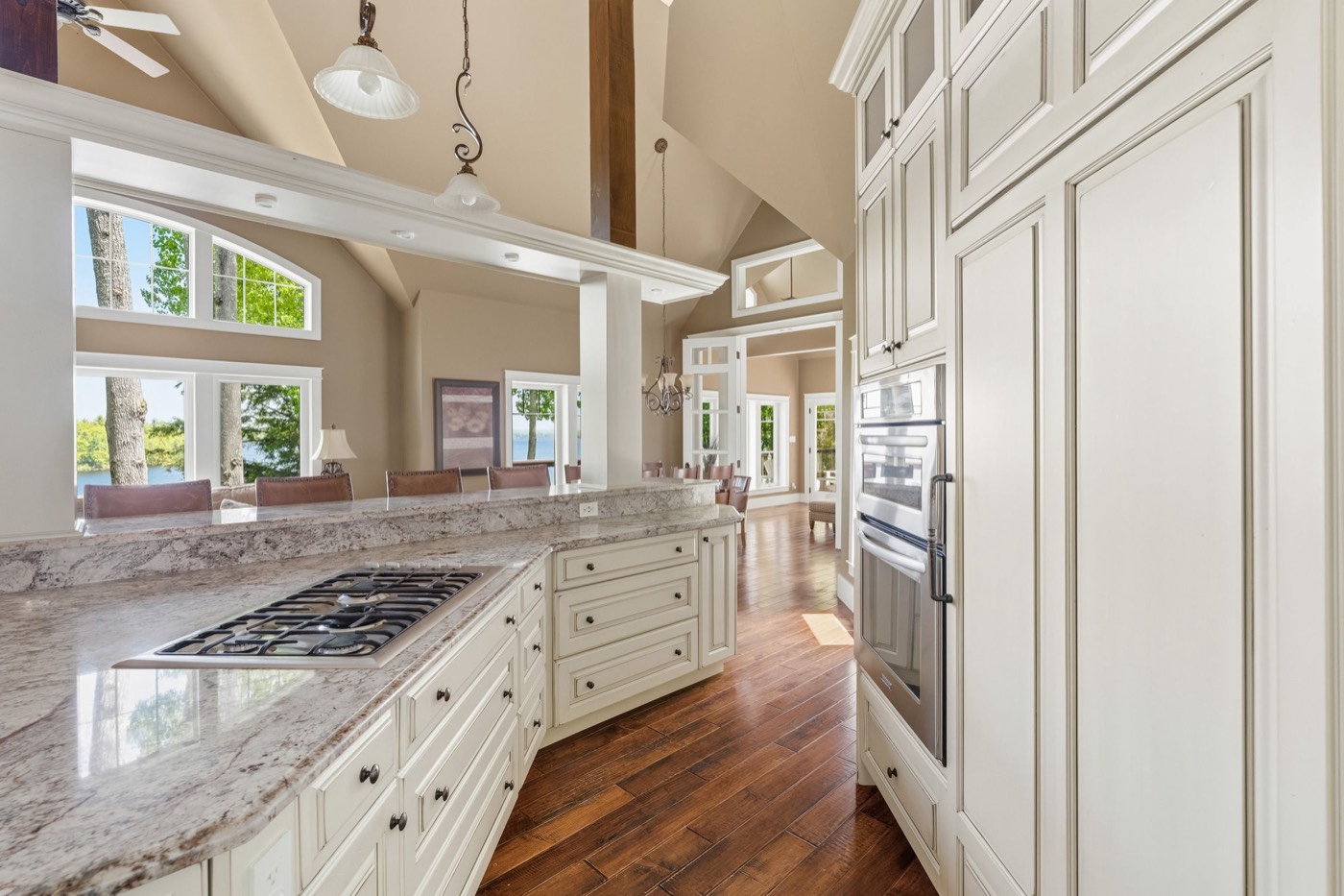 Chef's kitchen with marble counters and long lake views